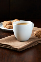 Cup of coffee on wooden background. Close up.