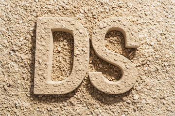 Letters D and S formed by small stones