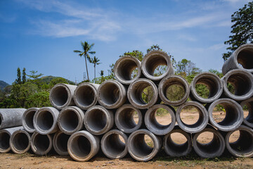 A stack of concrete ring pipes piled and creating a symmetrical arrangement