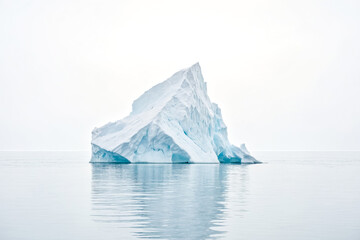 Single iceberg floating in calm waters