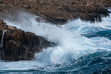 waves crashing on rocky coast. Windy weather , Powerful sea waves braking on rocks