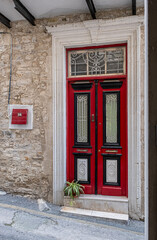 Fototapeta premium Pano Lefkara village, Larnaka region, Cyprus-May 24, 2024: Stone houses, white walls, narrow cobbled lanes, doors, windows, flowers, flowerpots, billboards, as seen in the village narrow streets 