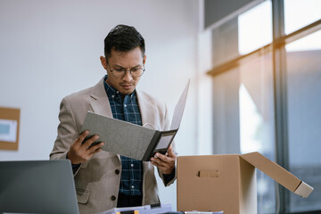 Successful businessman, excited young man packing up in office, job promotion concept, happy...