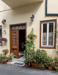 Pano Lefkara village, Larnaka region, Cyprus-May 24, 2024: Stone houses, white walls, narrow cobbled lanes, doors, windows, flowers, flowerpots, billboards, as seen in the village narrow streets 