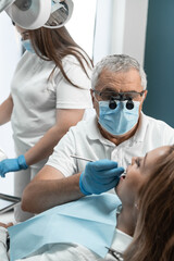 The dentist and his assistant perform effective teamwork during the treatment of the patient. Each...