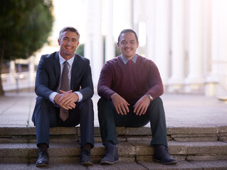 Business men, partner and sitting on stairs in portrait, city and smile on break outdoor in city....