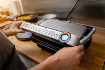 Chef cooking white bread toasted on an electric grill