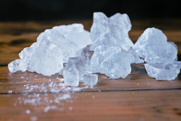 Natural rock salt on wooden surface