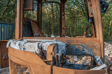 Burnt out construction digger by thieves.