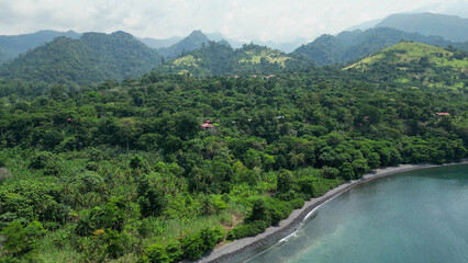 Aerial view of green hills along the shoreline. Sao Tome and Principe, Africa © Wirestock