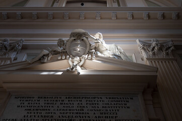 Entrance of a building with a statue on the door in the province of Pesaro and Urbino
