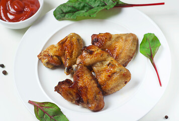 Fried chicken wings in a plate on the table