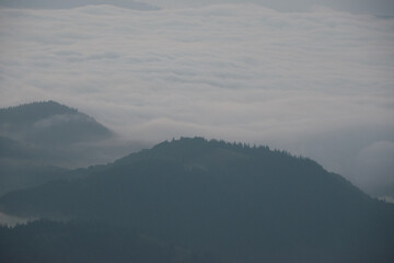 Aerial view of misty mountains and clouds