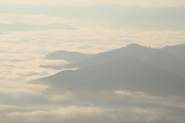 Misty clouds enveloping mountain peaks