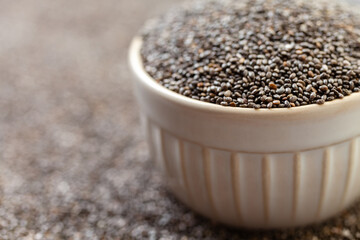 Chia seeds in bowl. Dry healthy supplement for proper nutrition.