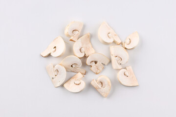 mushrooms champignons sliced into slices isolated on white background
