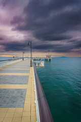 Pier extending into the water at sunset.