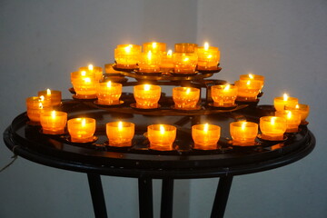 Multiple lit candles on a table.