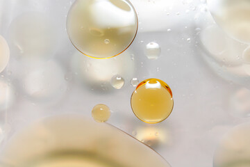 Drops of oil are on the surface of the water.