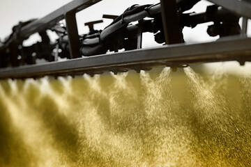 Closeup of a Tractor Sprayer spraying fertilizer onto a farmers field