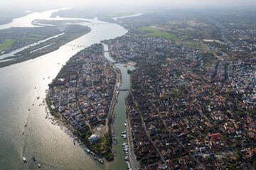 Contre-jour aerial view of Hoi An town and Thu Bon river. Vietnam.