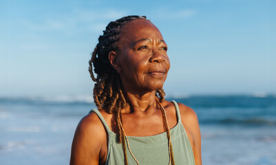 Serene moment with an older African American woman at the beach
