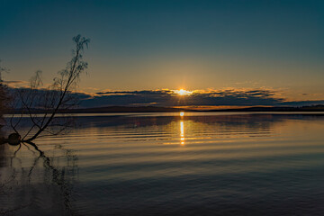Sunset over Lake Vasman in Ludvika County, Sweden and the colorful sky with clouds