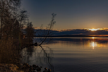 Sunset over Lake Vasman in Ludvika County, Sweden and the colorful sky with clouds