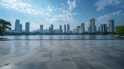 Empty cement floor with lake garden and modern city skyline in background. 
