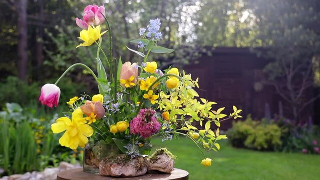 summer floral arrangement in a ceramic vase with kenzan of garden flowers, bouquet of seasonal flowers in the garden