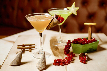 Table With Two Cocktail Glasses Filled With Drinks