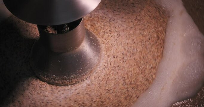 Closeup into the mash tank during the mashing process at a brewery