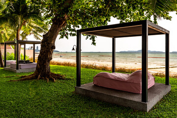 Gazebo by the beach on green lawn