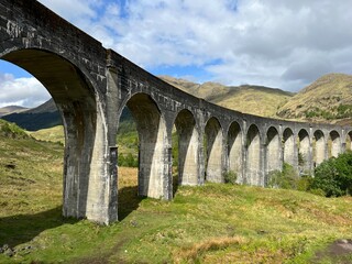 Vintage train on a bridge above a rural landscape in Scotland