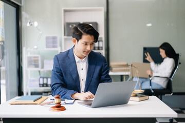 Asian man lawyer working and gavel, tablet, laptop in front, Advice justice and law concept...