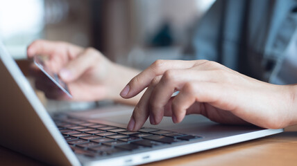 Internet payment, digital banking concept. Woman using laptop computer and credit card for online...