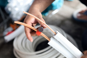 Industry construction system technician man worker cut joint with the tool of copper pipe system air conditioner average HVAC specialist