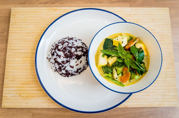 Traditional vegetable green curry with herbs and steamed rice