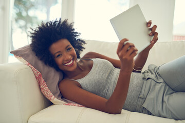 Black woman, happy and portrait with tablet on sofa for entertainment, social media or internet...