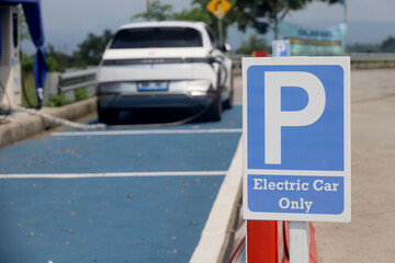 Electric car parking sign at EV station, electric car parking space reservation. public electric charging in the parking lot.