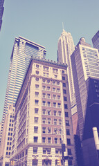 Looking up at New York skyscrapers, color toning applied, USA.