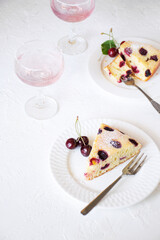 Plates with dessert, cherries, and cream