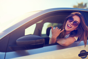 Woman, shaka and car by window in summer for travel, journey and vacation with sunglasses. Girl,...