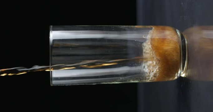 Cola soda can pouring in glass slow-motion, vertical view 4k prores