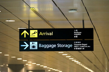 Arrival and luggage storage signs at Singapore Changi Airport.