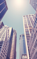 Looking up at New York skyscrapers, color toning applied, USA.