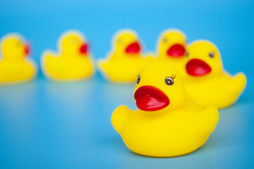 Close up of rubber duck leading other rubber duck with customizable space for text
