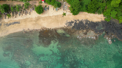 some very big pretty water by the shore with people in it