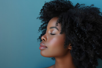 A close up of a black woman's face with her eyes closed looking to a side