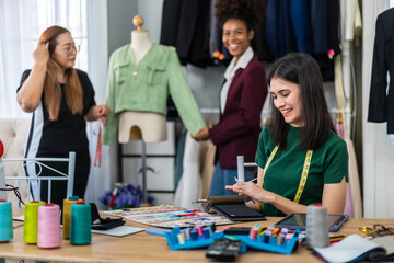 Collaboration and creativity in fashion design of teamwork, three diverse and talented designer collaborating on fabric swatches and design choices, creative studio, textile industry, fabric selection